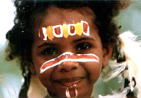 Smiling Aboriginal girl with face paint.